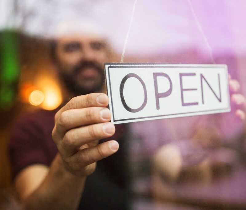 man with open banner at bar or restaurant window HFG Trust