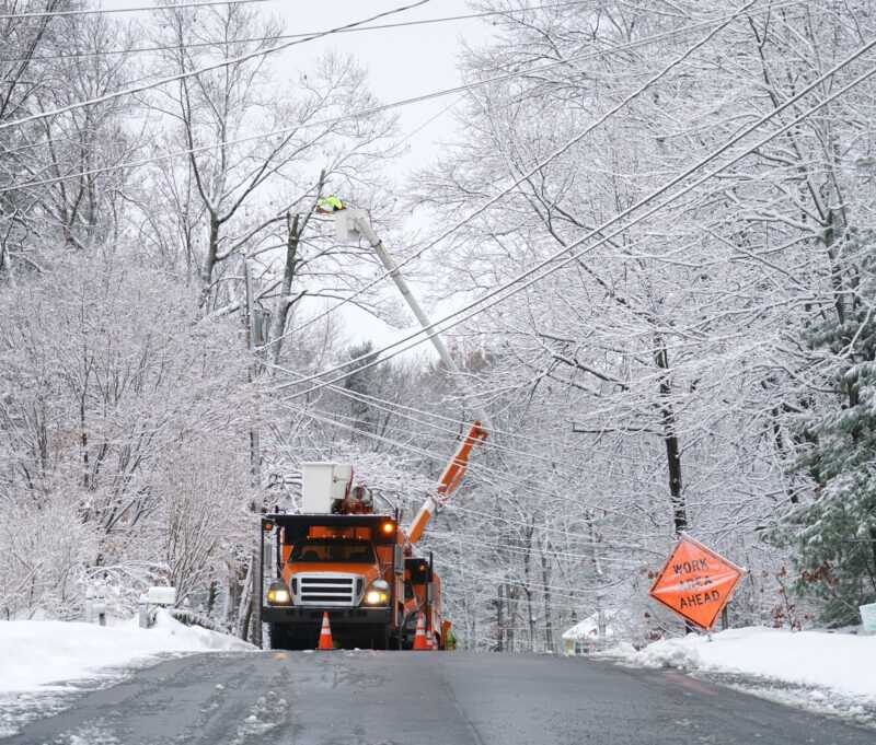 manual worker working on repair electrical line after winter snow storm HFG Trust