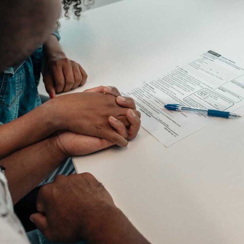 man and woman holding hands looking at a form unintentional inheritance HFG Trust