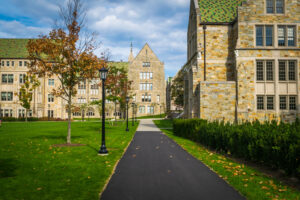 College campus walkway lined with stone Gothic buildings and autumn trees, illustrating college tax credits and 529 planning