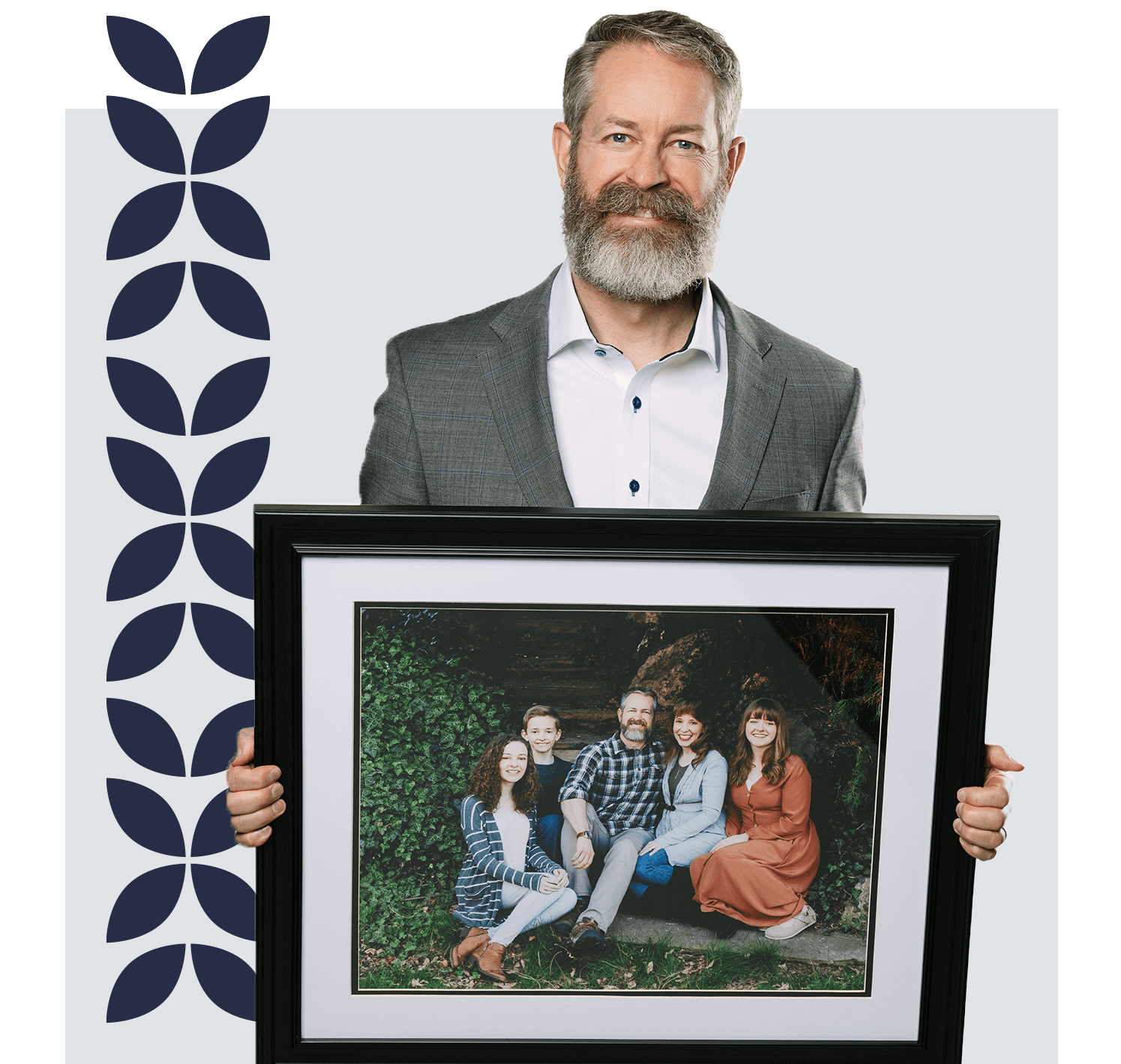 HFG Trust team member holding a family photo, symbolizing community roots, personal connection, and commitment to the Tri-Cities.