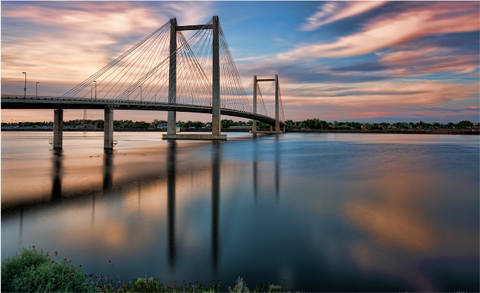 Cable Bridge in Kennewick, WA at sunset, symbolizing trusted wealth management and fiduciary financial advisors serving the Tri-Cities