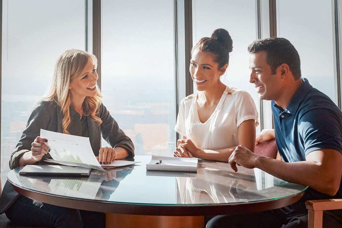 Financial planner meeting with clients to review investment goals and build a personalized financial strategy