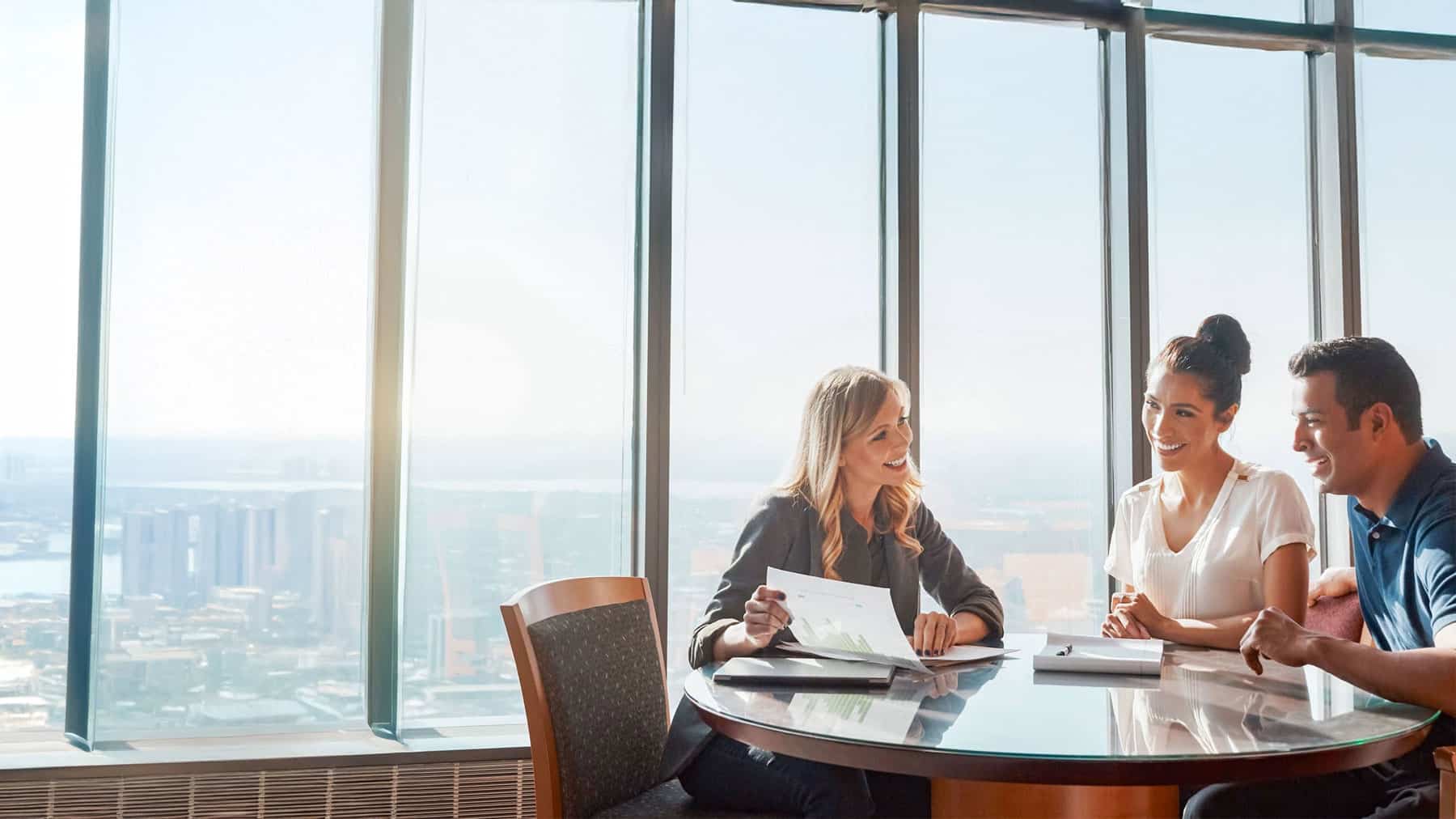 Couple meeting with financial planner to review personalized financial planning strategy in Kennewick, WA office.