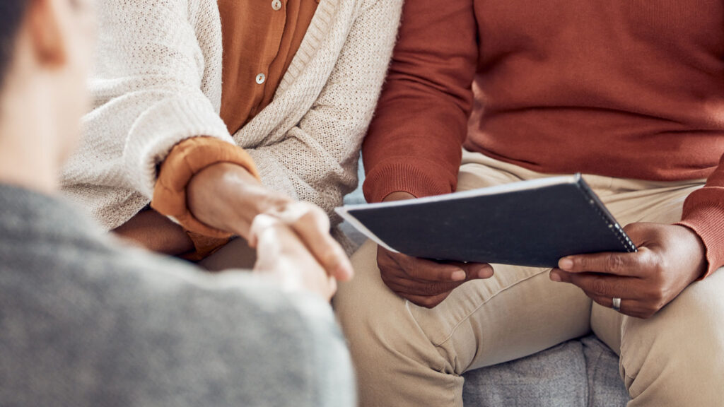 Signing day handshake with a fiduciary financial advisor, starting wealth management onboarding